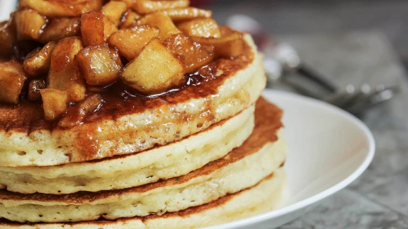 Stack of pancakes topped with apple compote