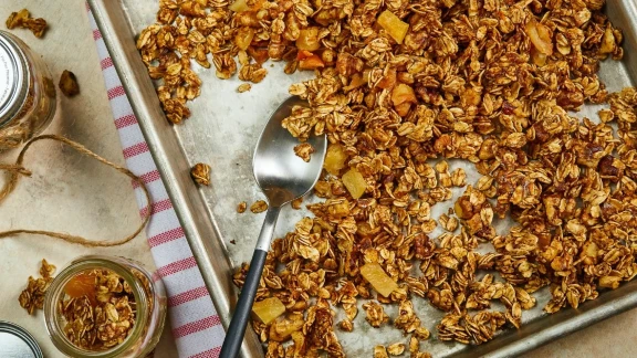 Homemade granola with dried fruit on a baking sheet