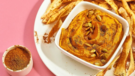 Pumpkin hummus with roasted seeds and pita chips