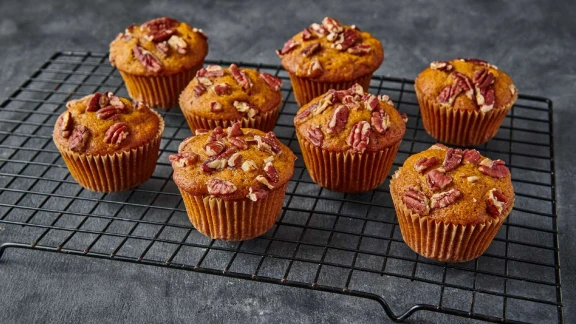 Pumpkin muffins with pecans on cooling rack