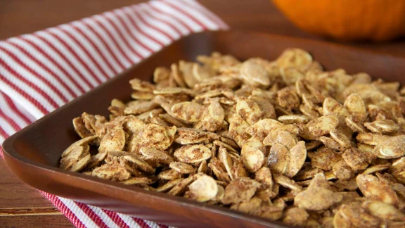 Cinnamon roasted pumpkin seeds on baking tray