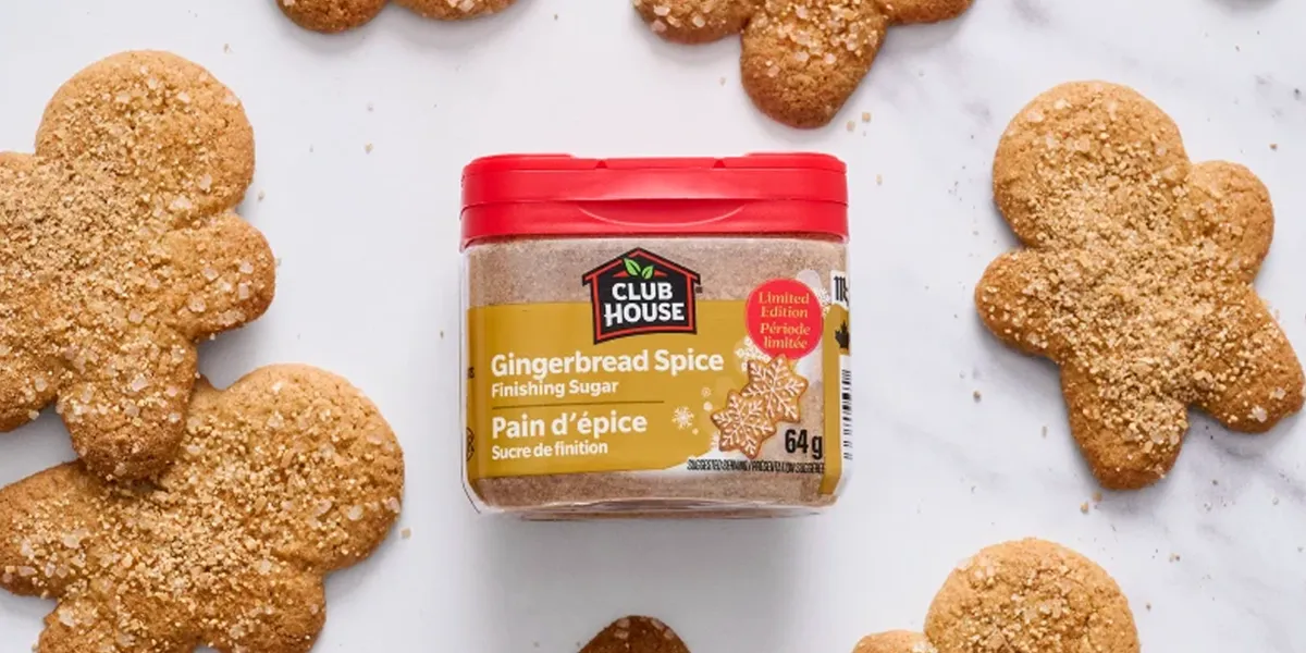 Club House Gingerbread Spice Finishing Sugar 64g with gingerbread cookies on marble surface