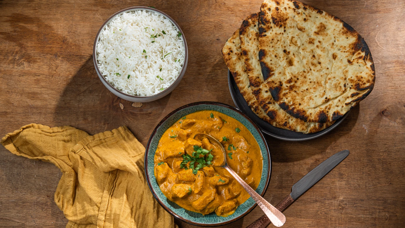 Butter chicken with naan and rice