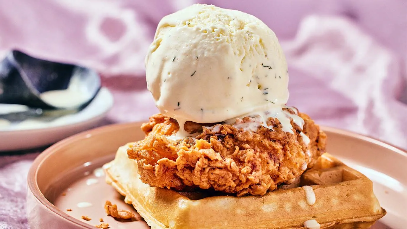 Scoop of buttermilk ranch ice cream on top of chicken and waffles