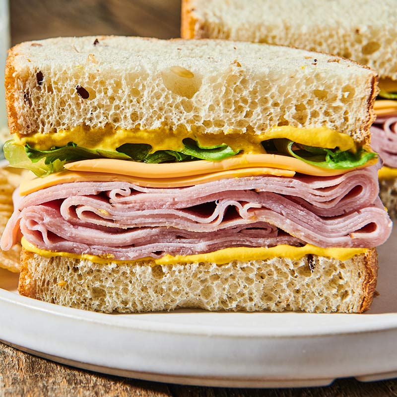 ham and cheese sandwich with creamy yellow mustard
